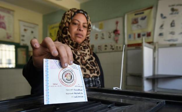 Una mujer deposita su voto en las elecciones de Egipto. /Afp
